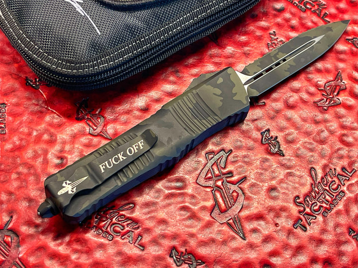 MARFIONE “Fuck Off” Combat Troodon, Double Edge Full Serrated, Od Green Cerakote Camouflage, Double Action OTF Knife