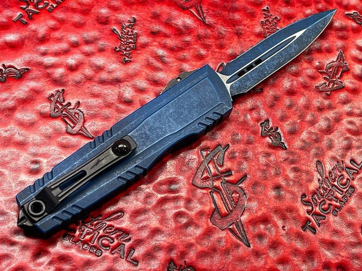 Microtech Luminary ZBP Double Edge Signature Series Weathered Blue Full Serrated Tritium Button Insert, (PRE OWNED) Double Action OTF Knife