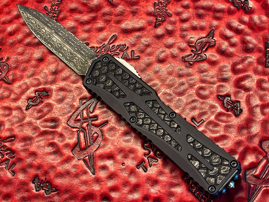 Heretic Knives Colossus, Hand Ground Double Edge, Vegas Forge Reptilian Damascus, Anodized Aluminum, Black Python Inlays, DLC Hardware, Double Action OTF Knife