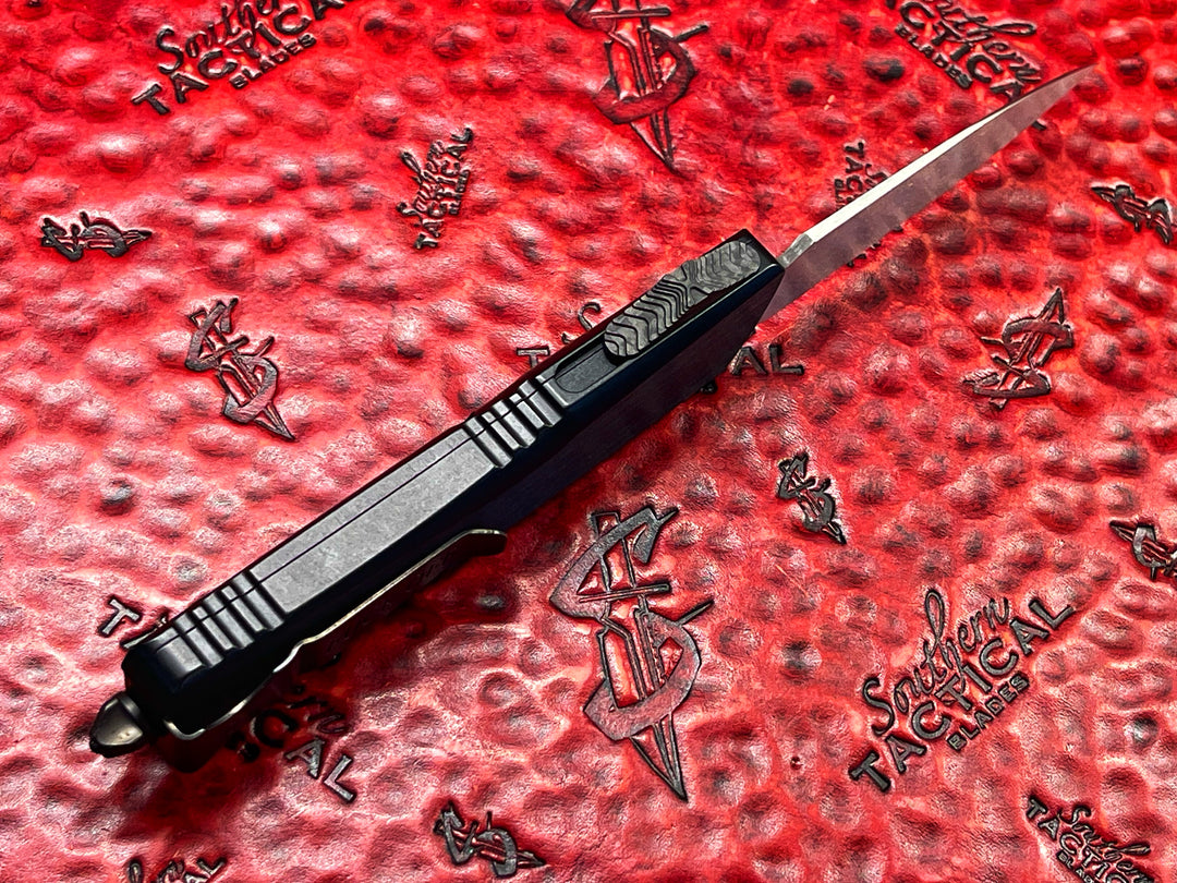 Marfione Custom Knives / Borka Blades Collaboration Combat Troodon, Chisel Grind, Borka Signature Rocker Grind, Black Hefted Aluminum Alloy Chassis, Carbon Fiber Button, DLC Two-Tone Hardware. DLC “Fuck Off” (Family Only) Pocket Clip. 1 of 3 Made.