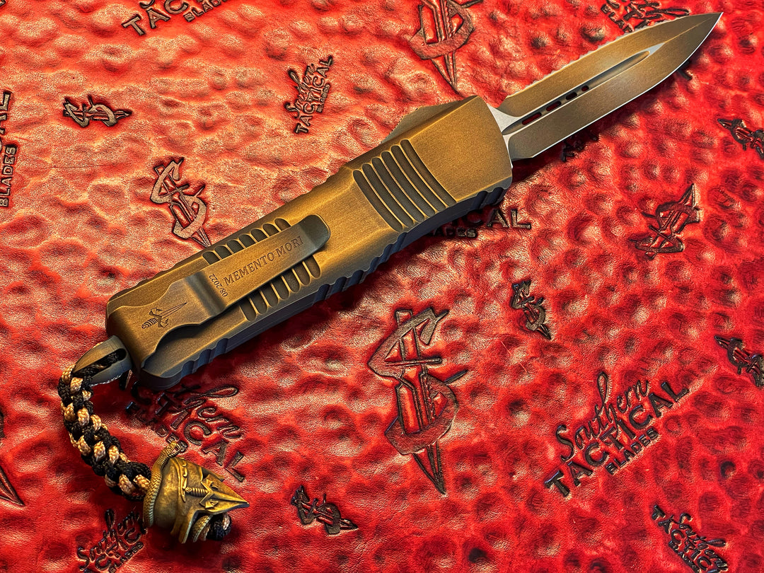 Marfione Custom Combat Troodon, Memento Mori, Double Edge, Full Serrated, Antique Bronze Cerakote w/  Matching Hardware, Spartan Meadow Viper Bead, Double Action OTF Knife 1 of 1