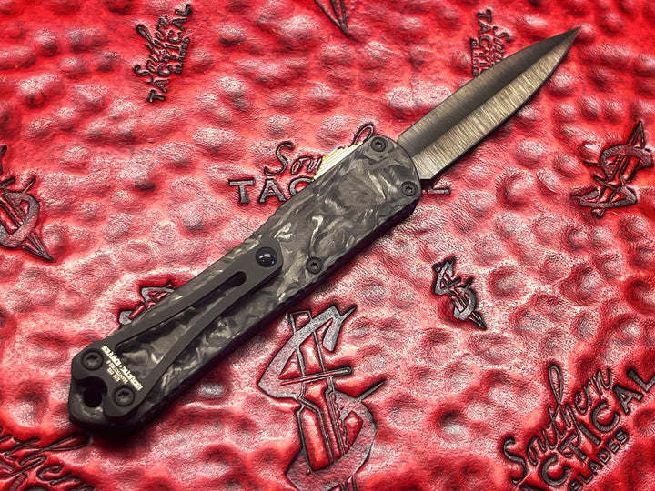 Heretic Knives Manticore S, Hand Ground Double Edge DLC, Black Anodized Alloy, Marbled Carbon Fiber Back Cover, DLC Hardware, Flamed Ti Button, Double Action OTF Knife