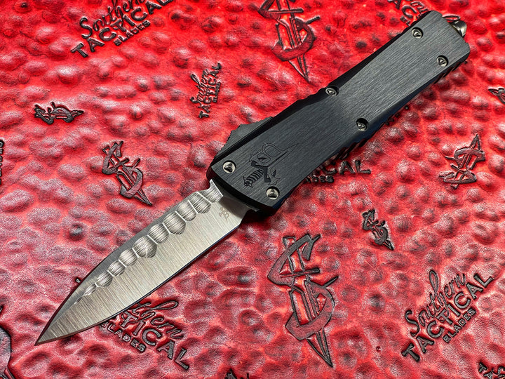 Marfione Custom Knives / Borka Blades Collaboration Combat Troodon, Chisel Grind, Borka Signature Rocker Grind, Black Hefted Aluminum Alloy Chassis, Carbon Fiber Button, DLC Two-Tone Hardware. DLC “Fuck Off” (Family Only) Pocket Clip. 1 of 3 Made.