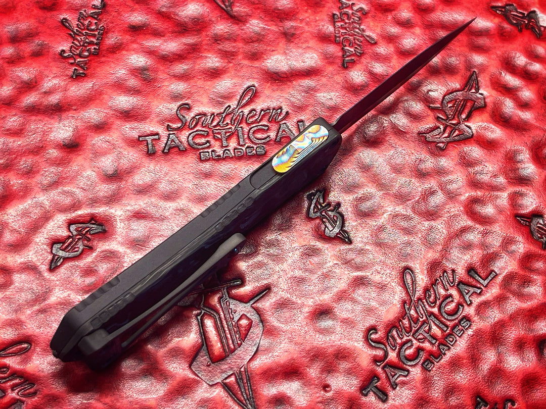 Heretic Knives Manticore S, Hand Ground Double Edge DLC, Black Anodized Alloy, Marbled Carbon Fiber Back Cover, DLC Hardware, Flamed Ti Button, Double Action OTF Knife