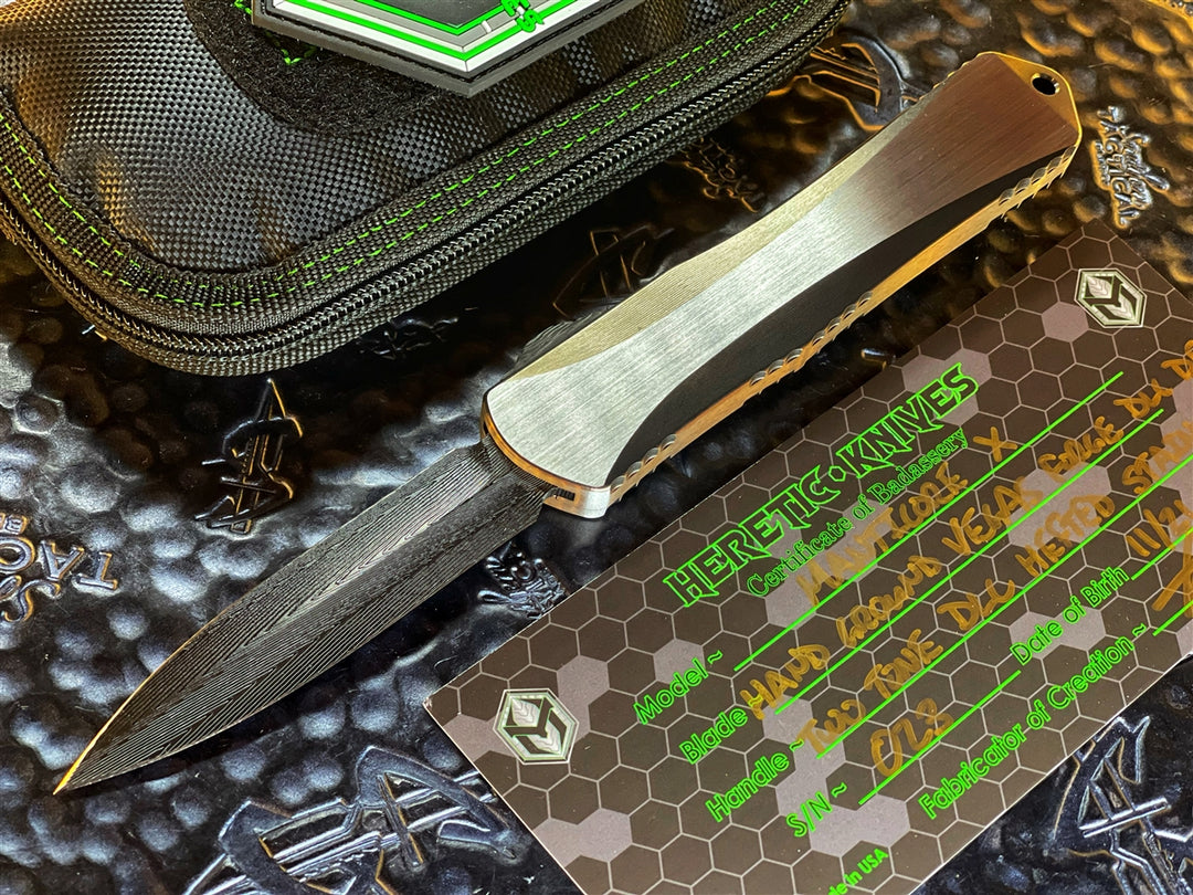 Heretic Knives Manticore X, DLC Vegas Forge HerringBone Damascus Spike Grind, Two Tone DLC Hefted Stainless Steel Chassis, Flamed Ti Accents w/ Carbon Fiber Button