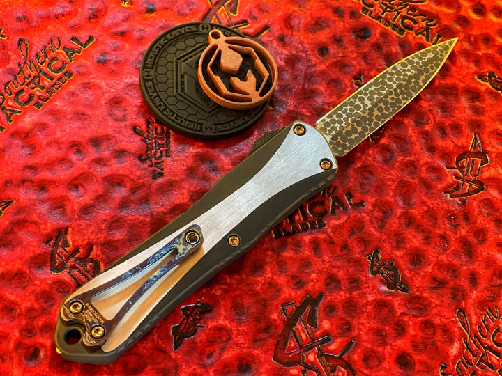 Heretic Knives Manticore E Double Edge, Hand Ground Vegas Forge Ball Bearing Damascus, Two Tone DLC Stainless Steel, Carbon Fiber Button, Bronze Ti Accents, Entropic Ti Clip