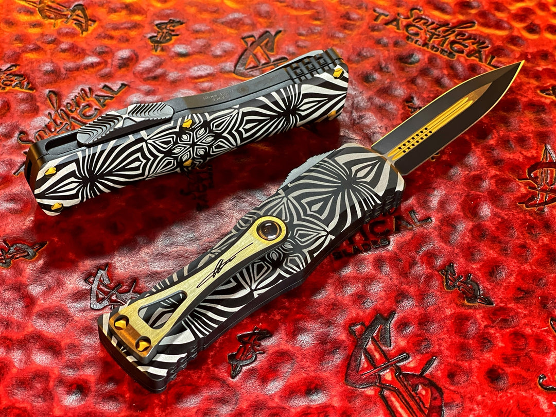 Microtech Hera Double Edge Two Toned Black w/ Gold Accents, Aircraft Alloy w/ ‘Source’ artwork
