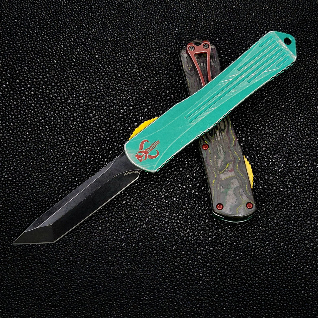 Heretic Knives Manticore X, Bounty Hunter ANO Handle w/Deep Engraved Red Logo, Camo Carbon Backcover, Tanto Battle Black, Battle Red Clip/Hardware, and Battle Yellow Button